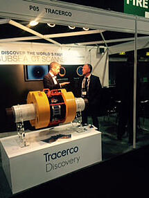 Two people standing with our Discovery technology at the exhibition stand