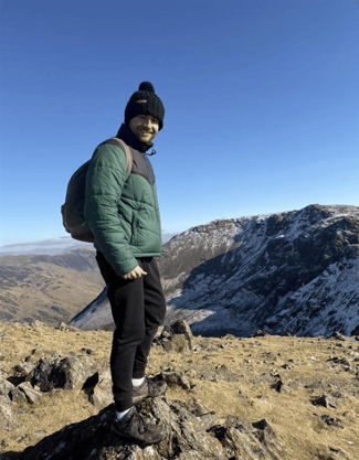 Tracerco's product manager, Bailey standing on mountain