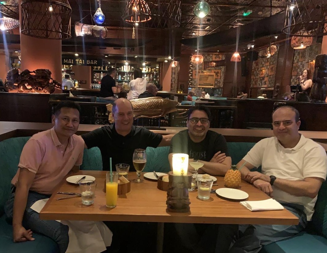 Four men seating at a dining table in a restaurant