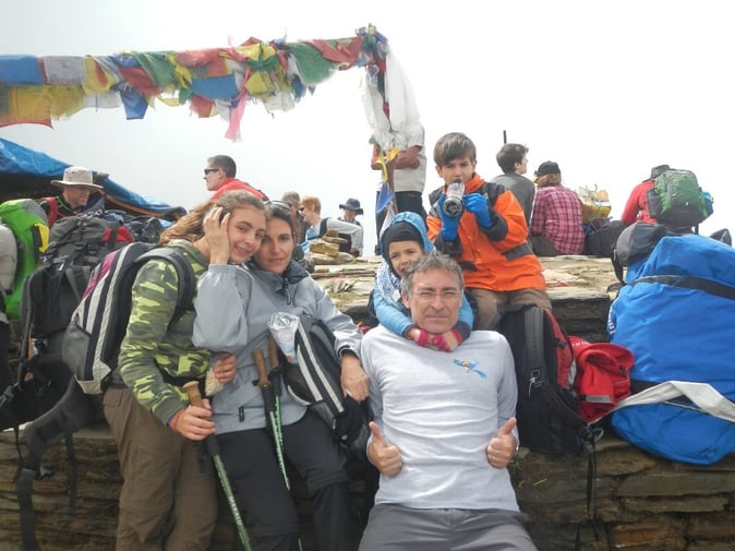 Francesco Falsini and family seating on a bench