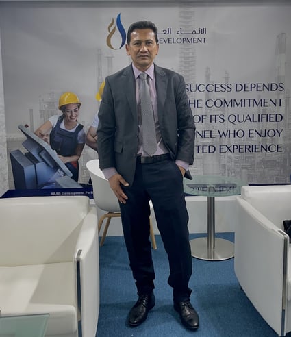man standing in between sofas at an oil and gas office