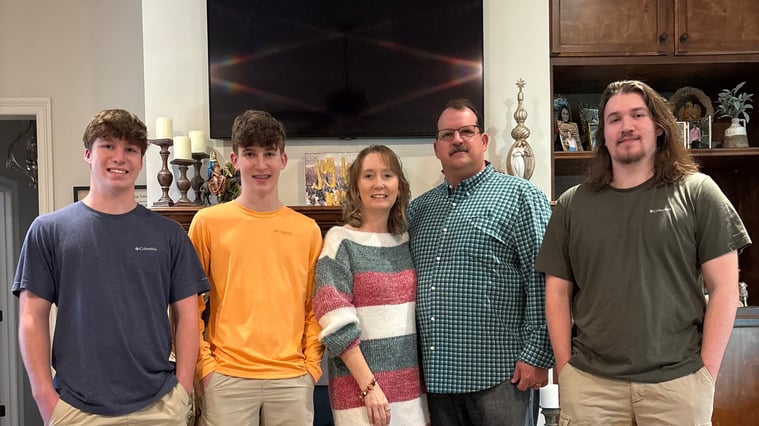 Andy Burleigh standing with his wife and 3 children